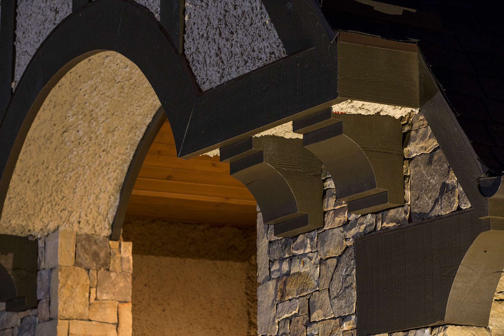 Cross-timber, stucco and stone facade close-up in custom-build Tudor home in Asheville, North Carolina.