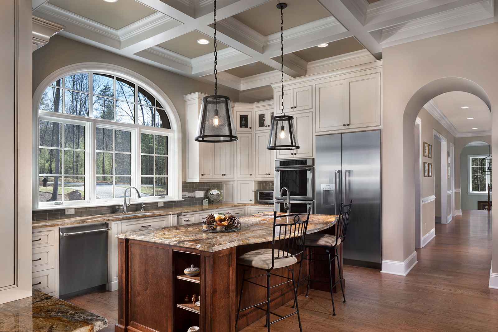 Arched doorways and windows in the kitchen of a custom-built modern Tudor home.