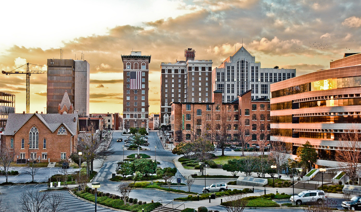 cityscape with tall buildings of Greenville, South Carolina at sunrise.