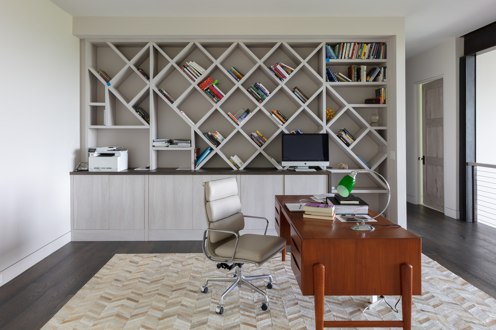 Custom designed home office with built-in shelves and inlaid flooring. Scandinavian meets mountain design.