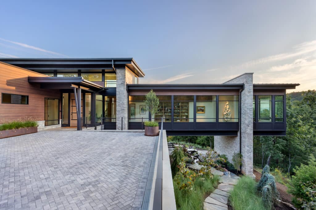 modern glass hallway; art display; natural light; Blue Ridge views.