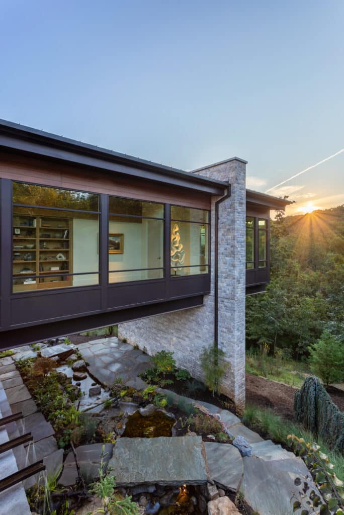 cantilevered primary suite; water feature; modern home Greenville SC; steel beams over water.