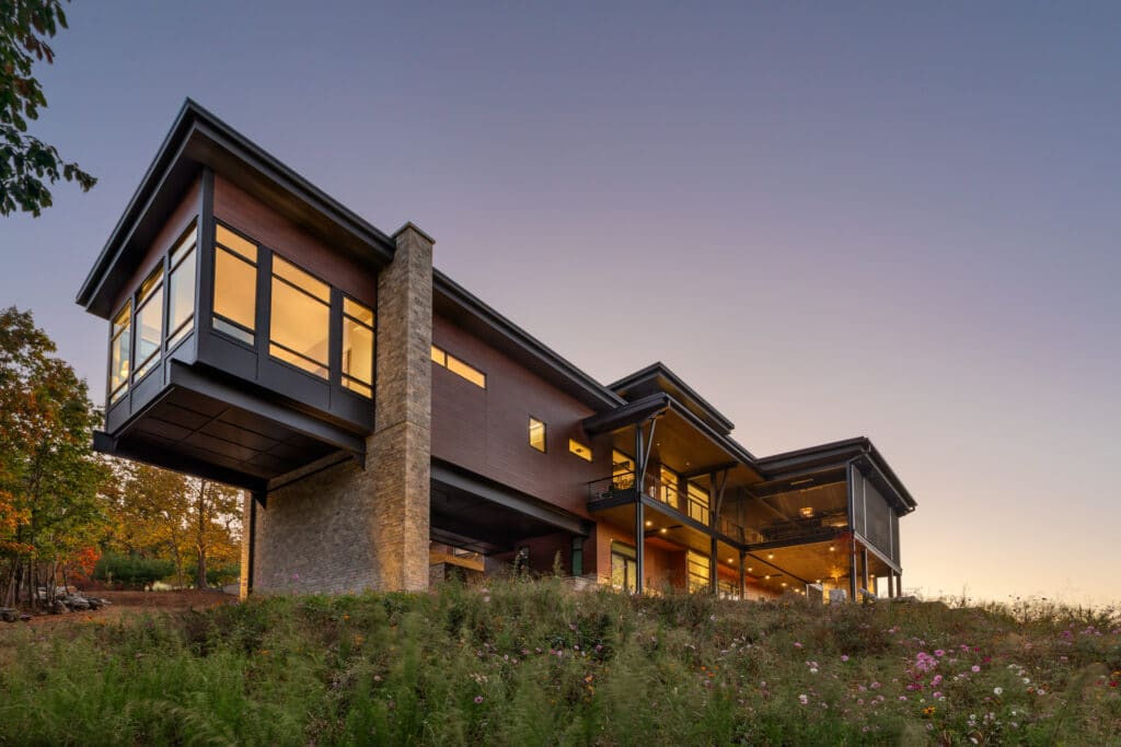 modern luxury home at dusk; illuminated architecture; Blue Ridge mountain home. 